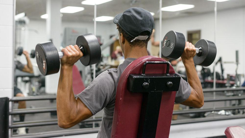 A student lifts weights